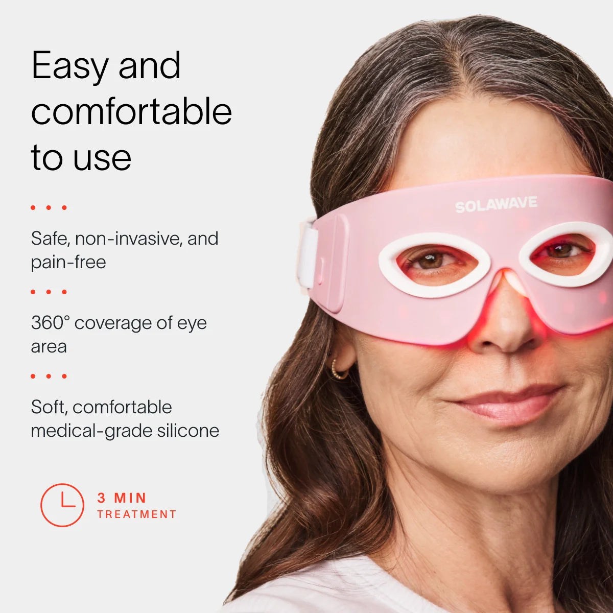 A woman enjoys the soothing benefits of the pink Eye Recovery Pro Kit by SolaWave, featuring 360-degree eye coverage and a soft silicone design. With LightBoost technology, it ensures safe, non-invasive treatments in just 3 minutes.  