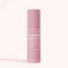 A pink cylindrical bottle of Solawave Light Therapy Boosting Wand Activating Serum, featuring white text and formulated to enhance light therapy with your skincare wand, stands upright against a light beige background.