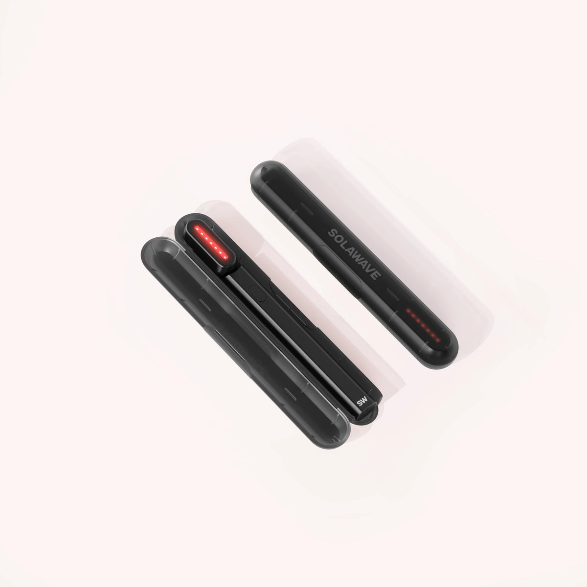 On a light background, three sleek black handheld devices with rounded edges are stacked, each featuring a glowing red strip and the SOLAWAVE text, suggesting their Radiant Renewal Skincare Wand Replacement Carrying Case capabilities. || Black